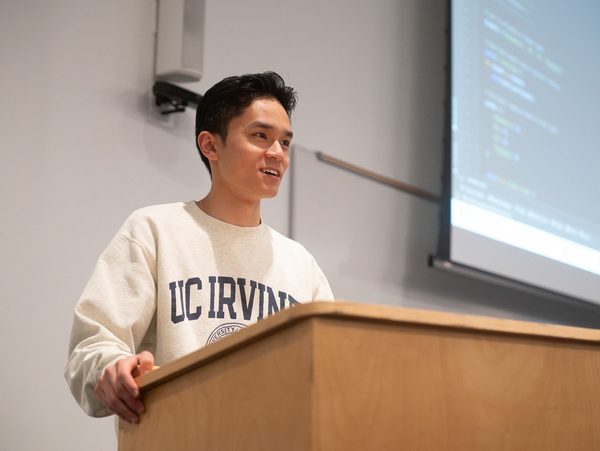 Brian guest-lecturing at a lectern.